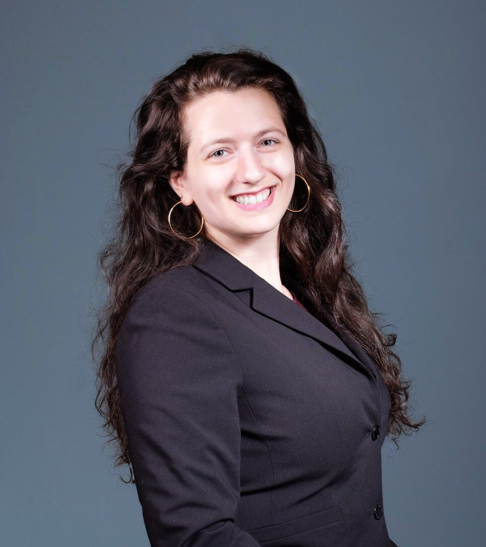 Woman with long brown hair wearing blazer